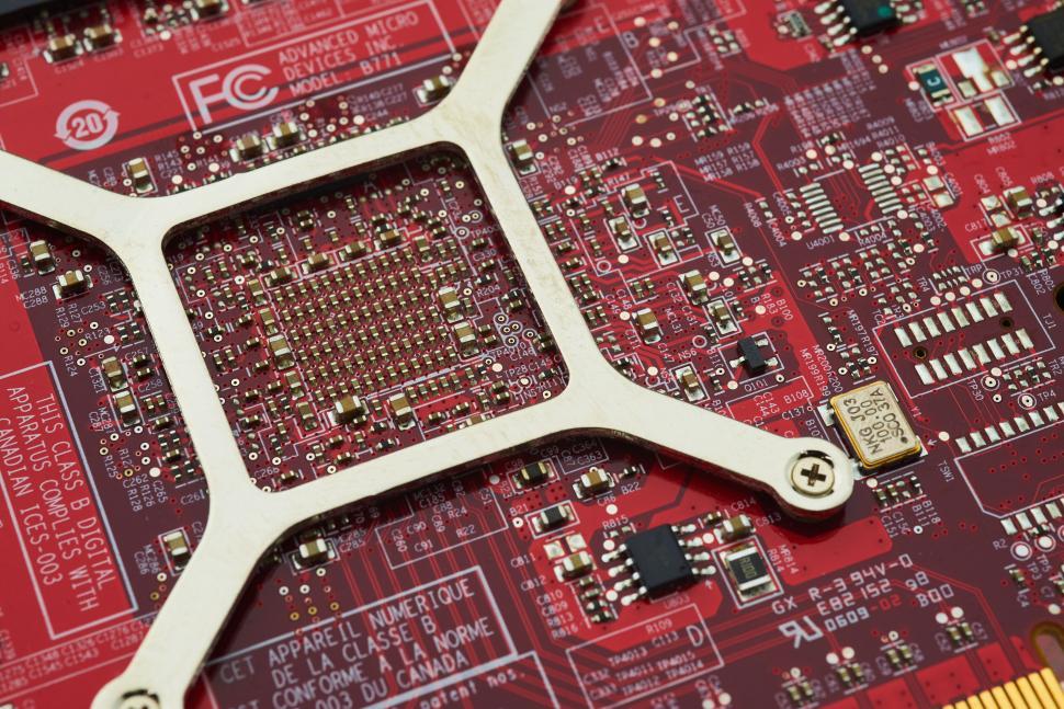 Free Image of Detailed view of a red circuit board with embedded gold connector 