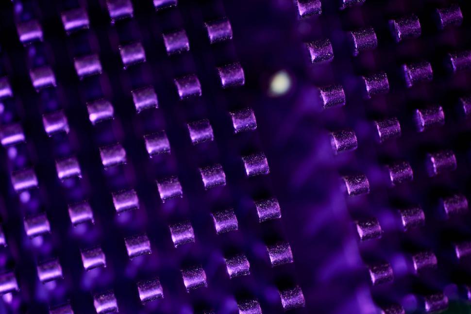 Free Image of Close-up of illuminated circuit board with purple light effects 