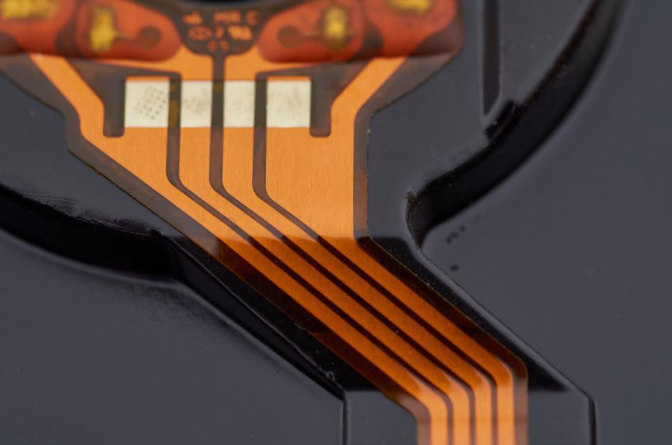 Free Image of Close-up view of flexible circuit with orange conductive paths 