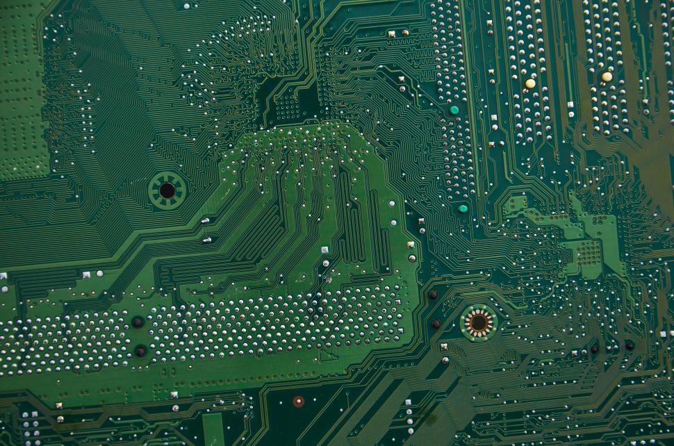Free Image of Green printed circuit board showcasing intricate electrical layout 