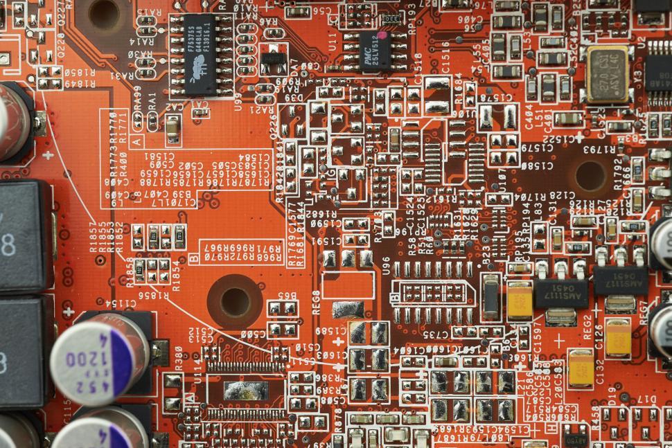 Free Image of Close-up of red circuit board with densely packed components 