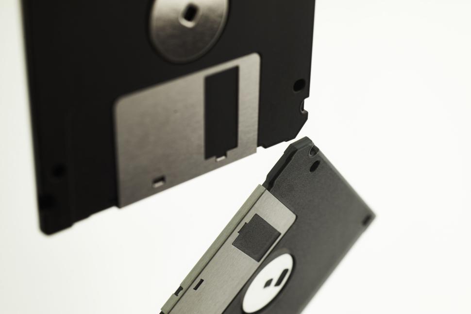 Free Image of Pair of black floppy disks featuring silver and black metal shutters. 