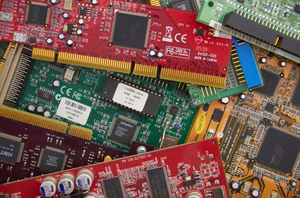 Free Image of Assorted colorful circuit boards piled on top of each other. 