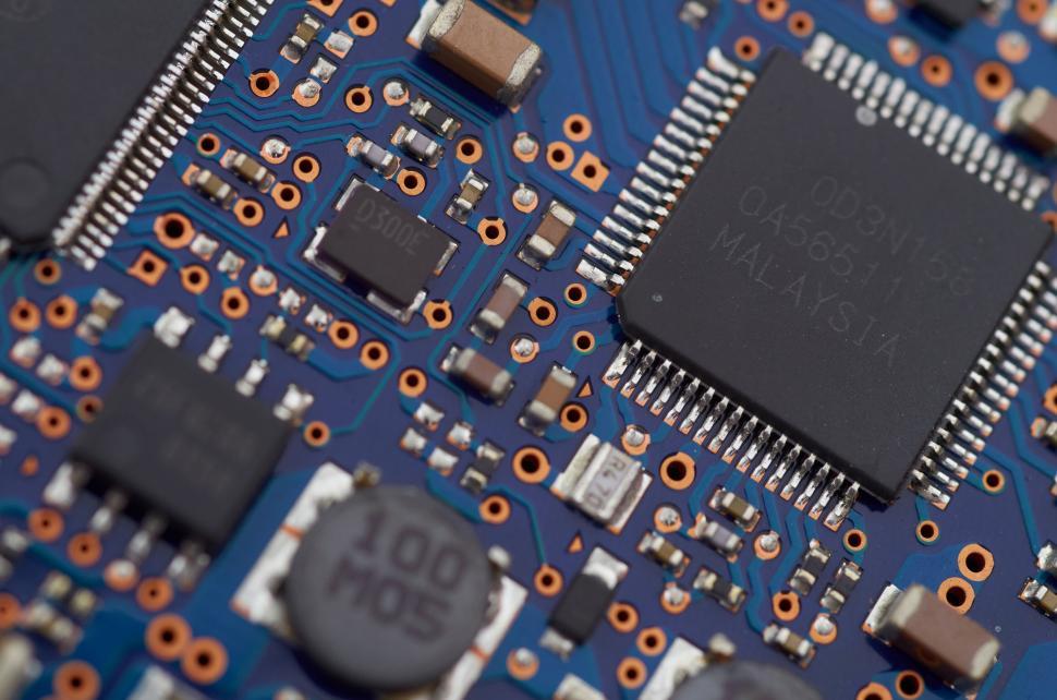 Free Image of Detailed view of a blue circuit board with various components. 