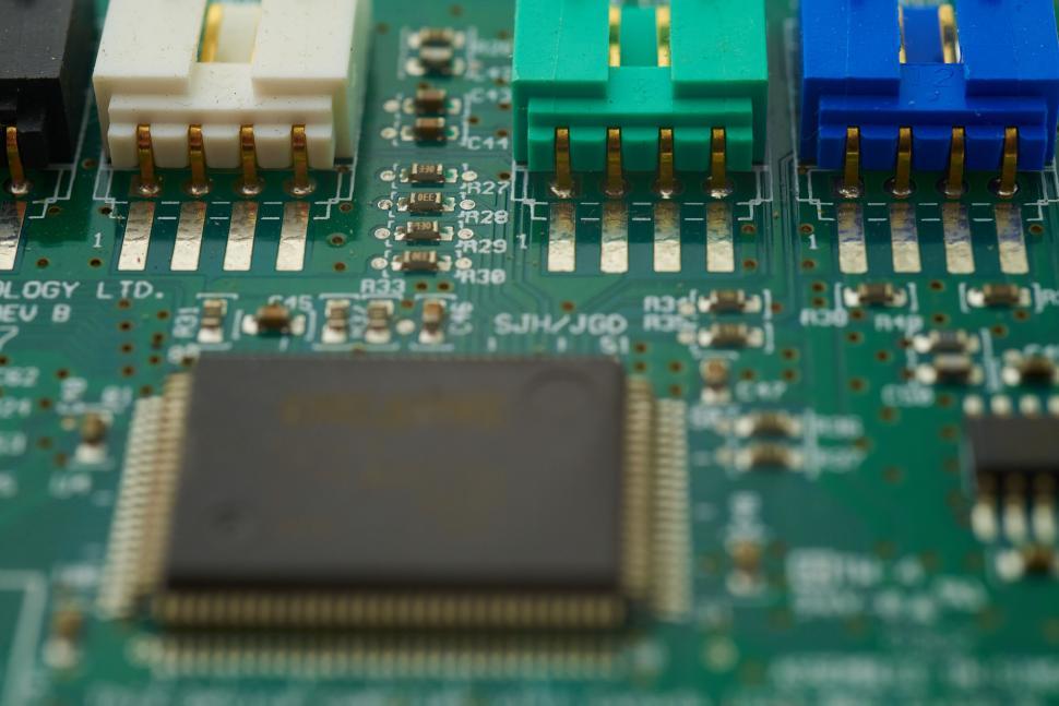 Free Image of Macro shot of a green circuit board with colorful connectors. 