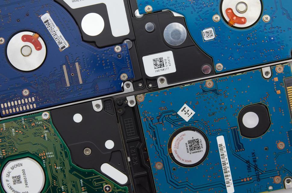 Free Image of Collection of colorful hard disk drives showing exposed circuit boards 