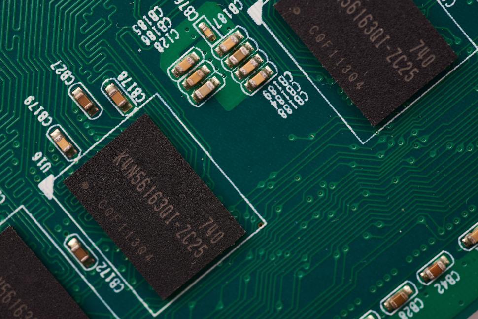 Free Image of Green printed circuit board with intricate chip design and circuits. 