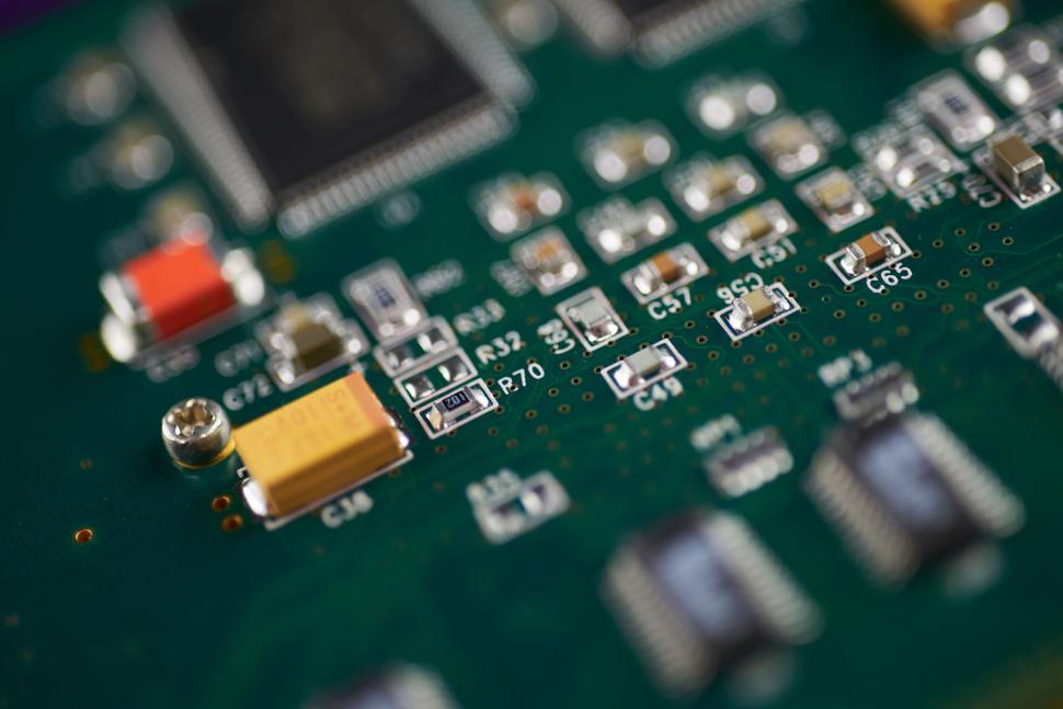 Free Image of Detailed green circuit board with various electrical components mounted. 