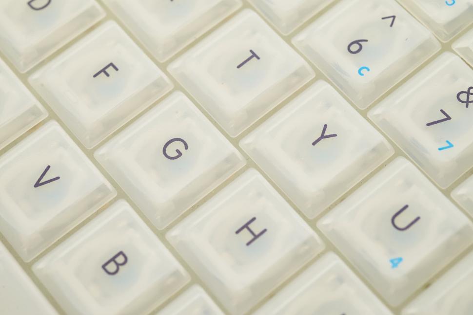 Free Image of Close-up of white keyboard keys with letters and blue numbers. 