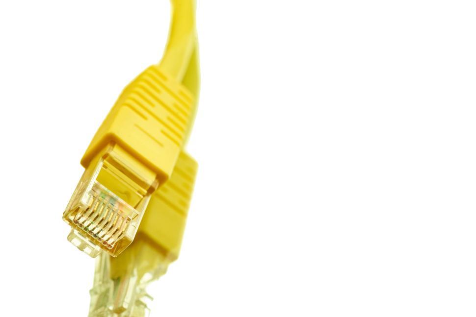 Free Image of Yellow ethernet cable with clear connectors on a white background. 