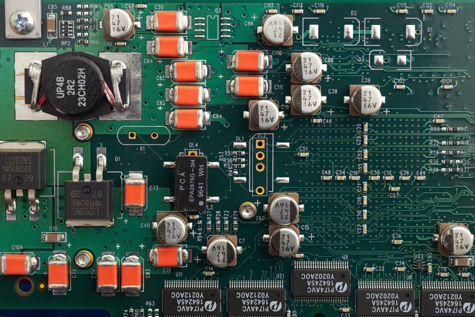 Free Image of Green electronic circuit board with various components and connectors 