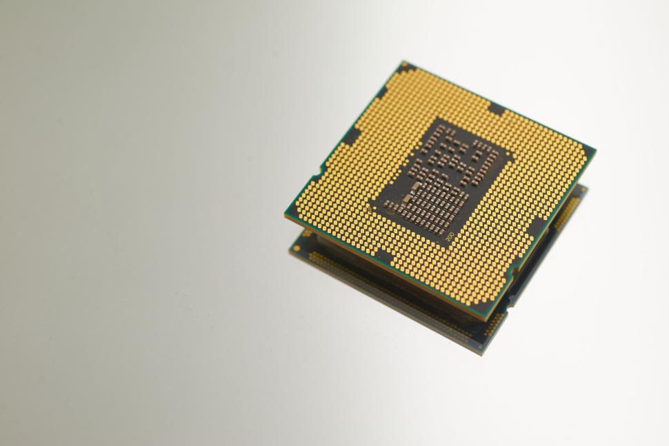 Free Image of Close-up view of a CPU microprocessor chip on grey surface 