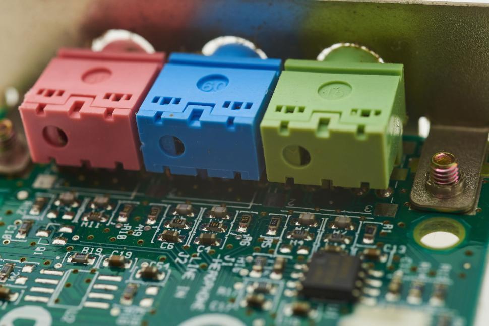 Free Image of Close-up view of colored audio jacks on a green circuit board 