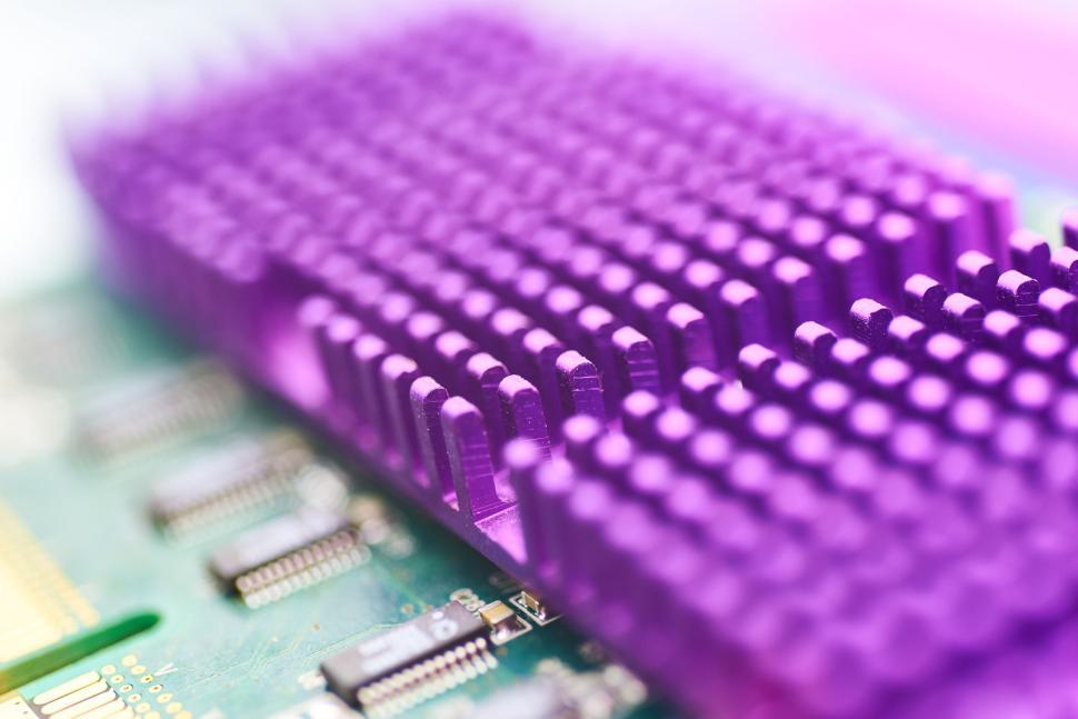 Free Image of Modern electronic component with purple heatsink close-up view. 