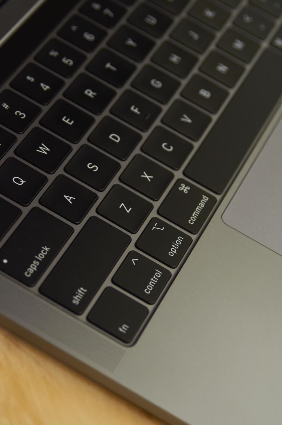 Free Image of Black compact laptop keyboard with trackpad in minimalistic design. 