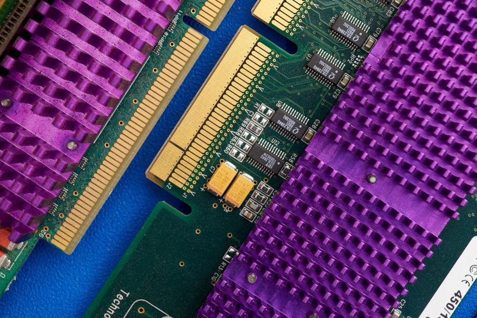 Free Image of Close-up of computer circuit board with purple heat sinks 