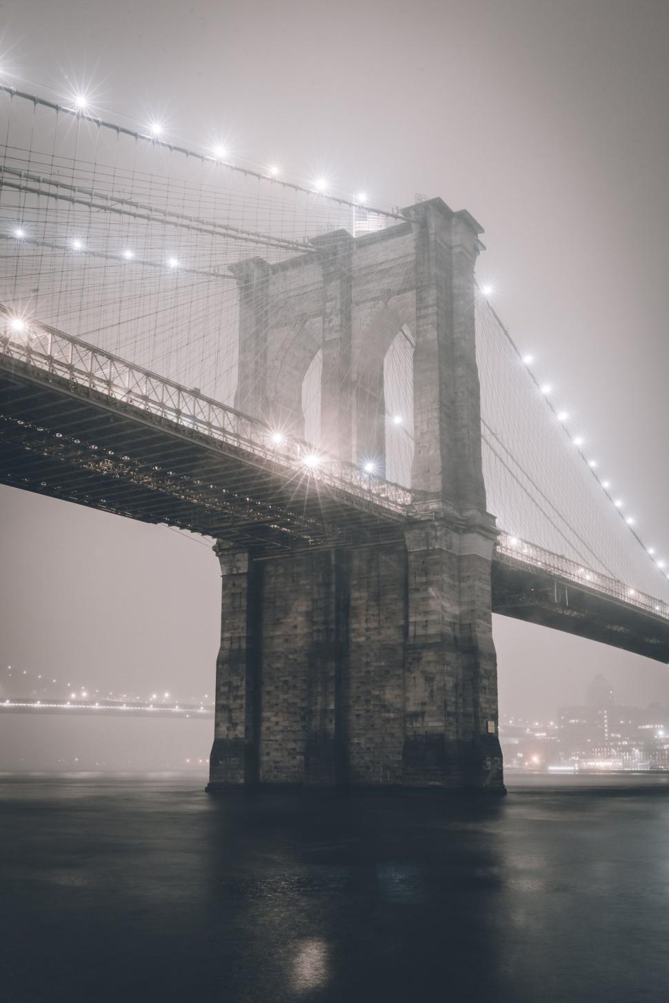 Free Image of Misty night view of a beautifully lit iconic bridge structure. 