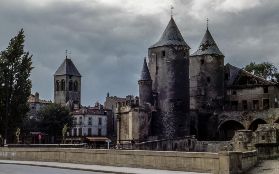 Free Image of Ancient castle with stone towers and medieval architecture under clouds 
