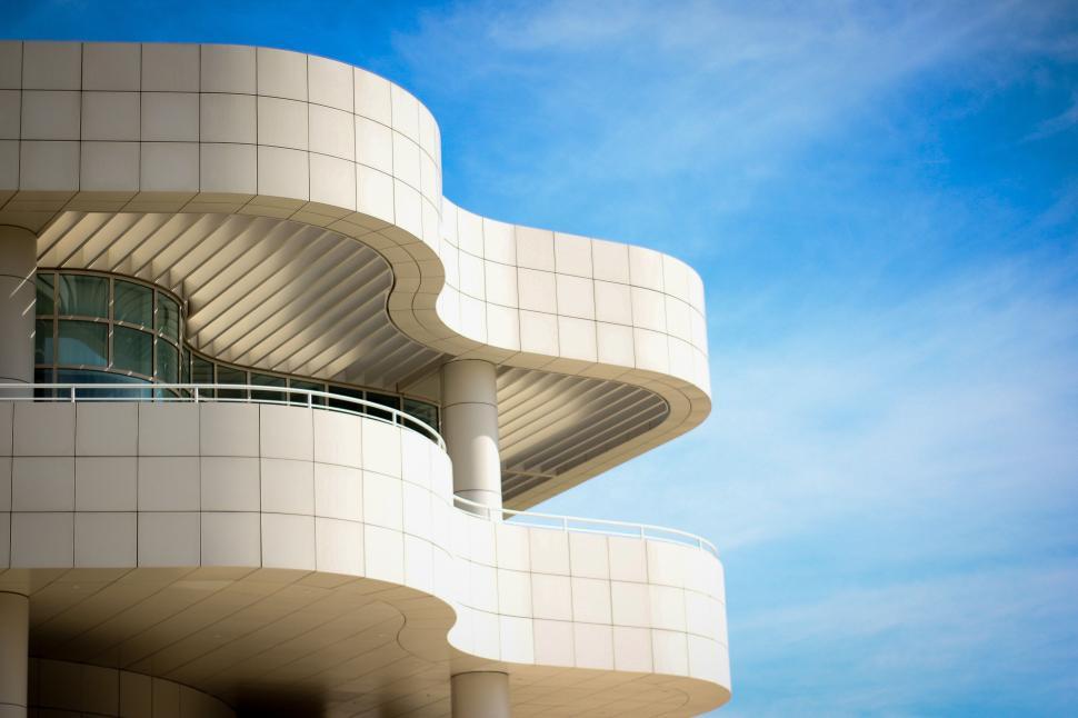 Free Image of Modern white curved building architecture on a clear sunny day. 