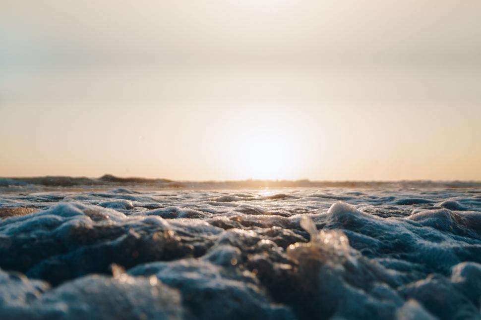 Free Image of Waves of the ocean under a sunset horizon view from sea level. 