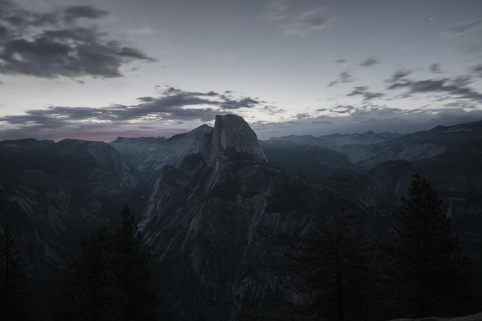 Free Image of Mountain peak at twilight with a serene sky and valley below. 