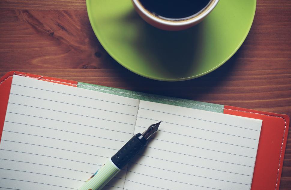 Free Image of Open notebook with pen and cup of coffee for writing and brainstorming 