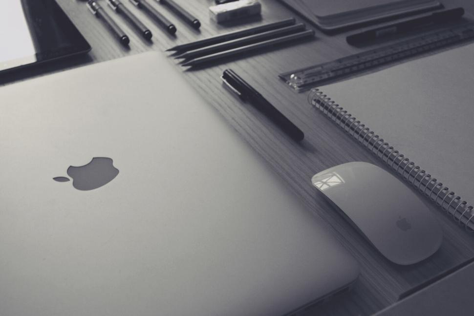 Free Image of Monochrome workspace with laptop, mouse, and notebooks 