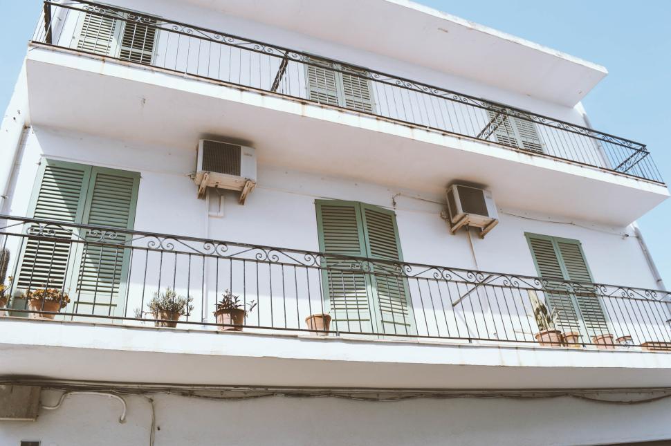 Free Image of Three-story building with balconies and air conditioning units 