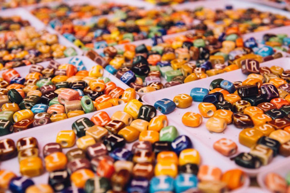 Free Image of Colorful candies displayed on a tray, creating a vibrant mosaic pattern. 