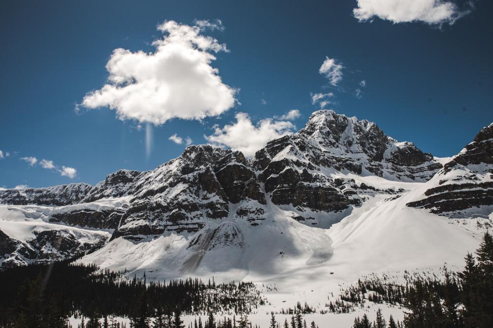 Free Image of Snow-capped mountains under a bright blue sky on a clear sunny day. 