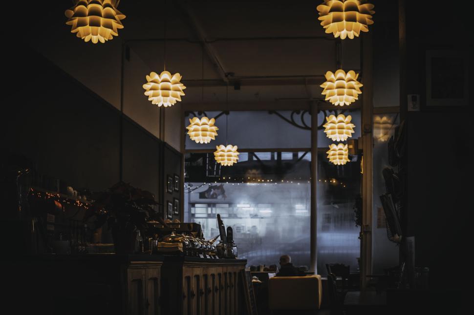 Free Image of Cozy cafe interior with warm lighting and soft background lights 