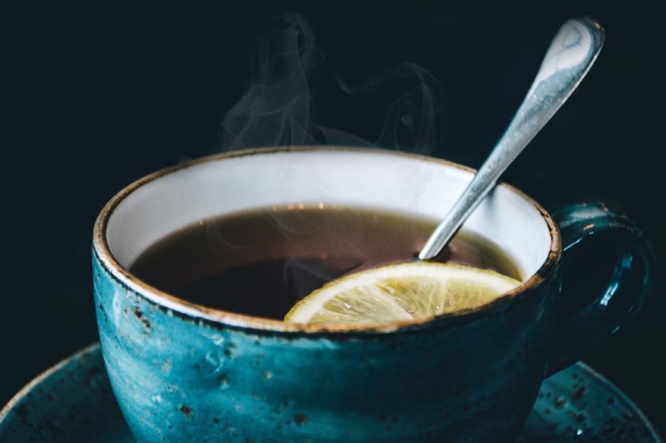 Free Image of Blue cup of hot tea with a lemon slice and spoon on top 