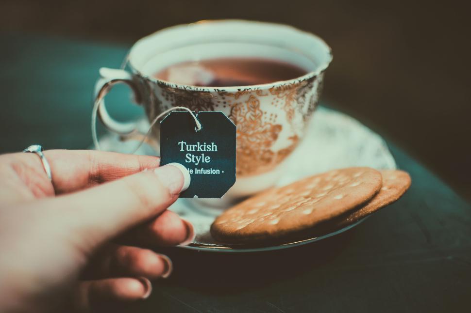 Free Image of Cup of Turkish-style tea with biscuits on a decorated table setup. 