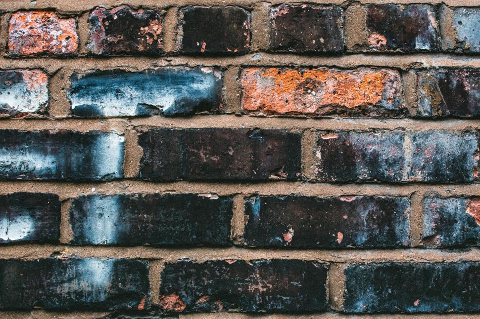 Free Image of Close-up of weathered brick wall showcasing unique texture and colors 