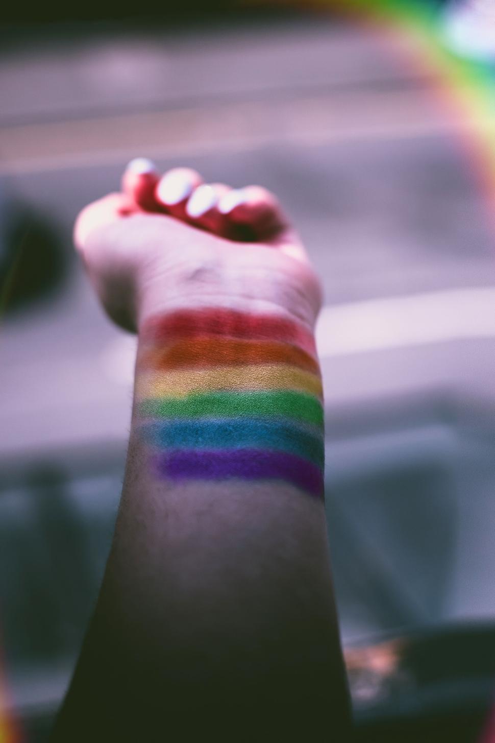 Free Image of Rainbow pride flag painted on forearm symbolizing LGBT support 