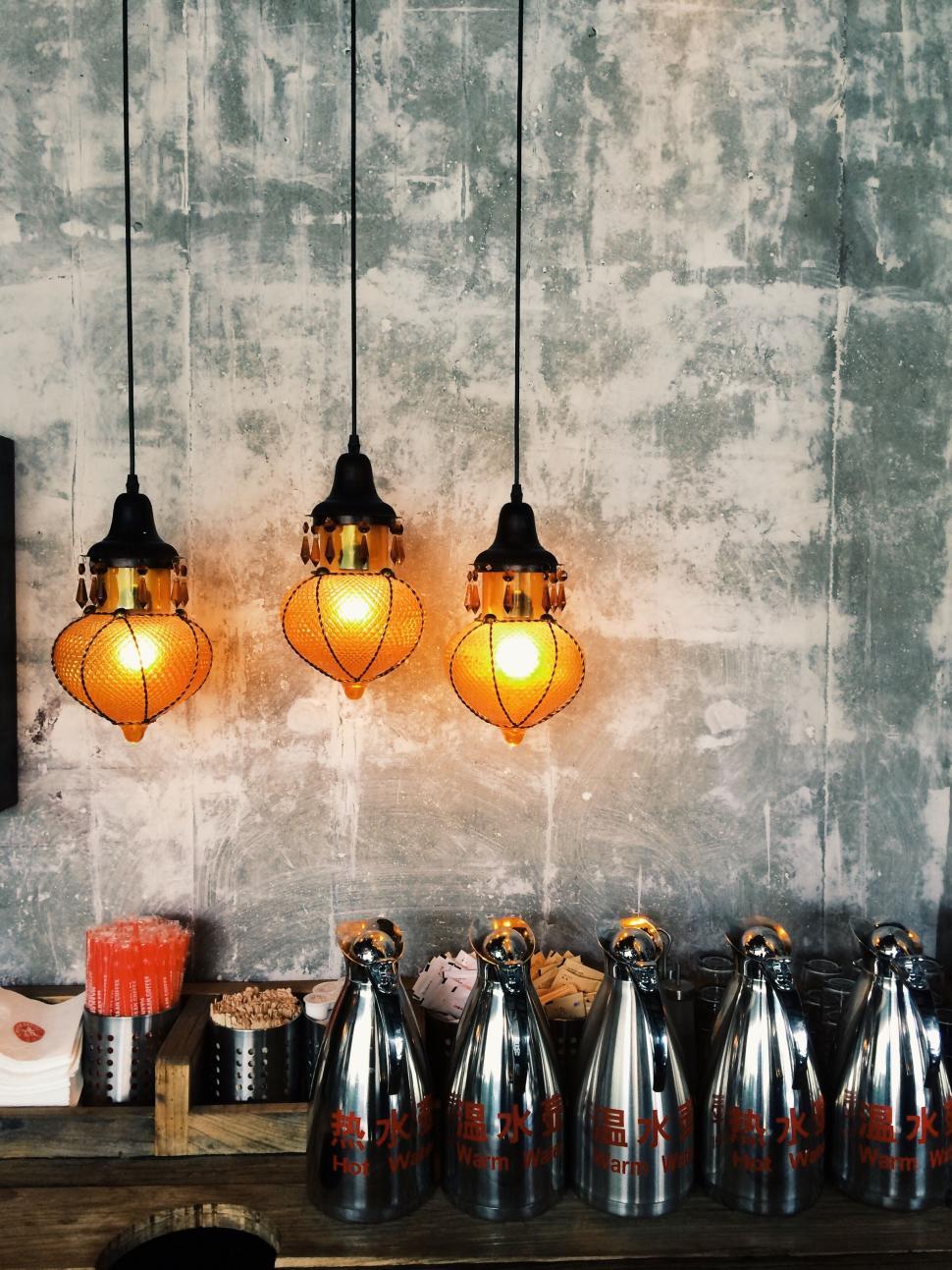 Free Image of Vintage pendant lights above a rustic counter with various items below. 