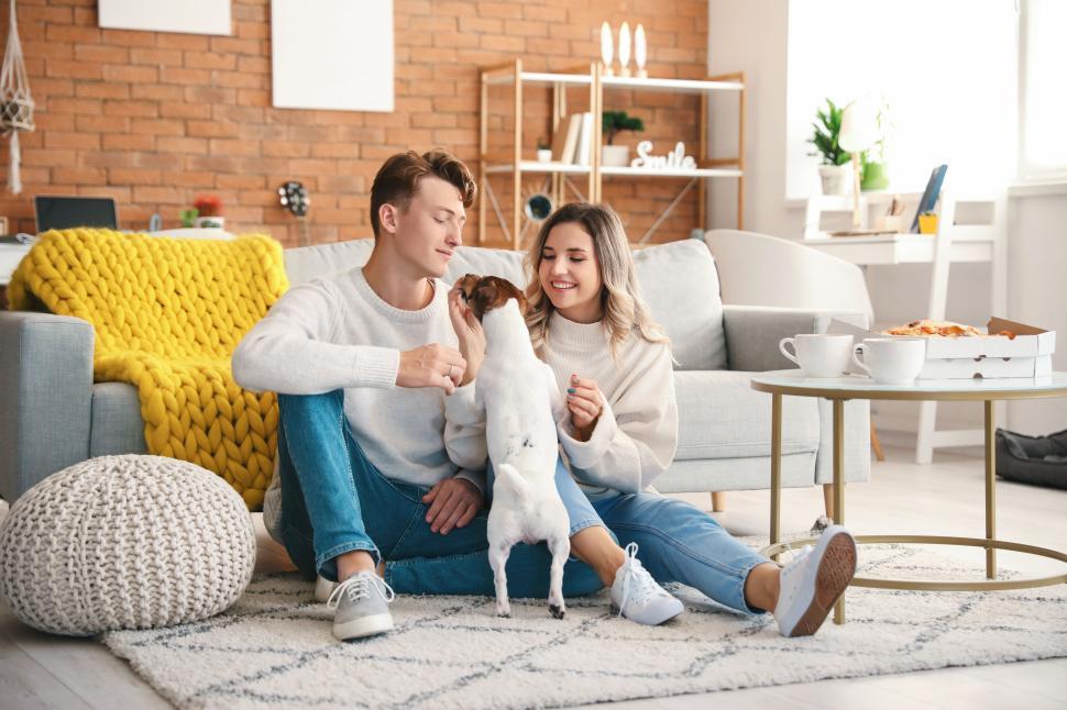 Free Image of A couple and their dog relaxing in a cozy living room 
