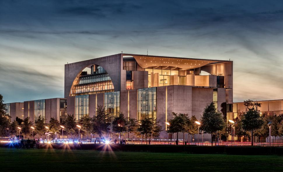 Free Image of Modern architectural building with lit windows at dusk in urban area. 