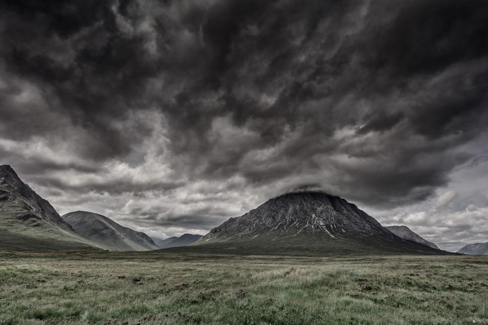 Free Image of Majestic mountain under dramatic swirling dark storm clouds 