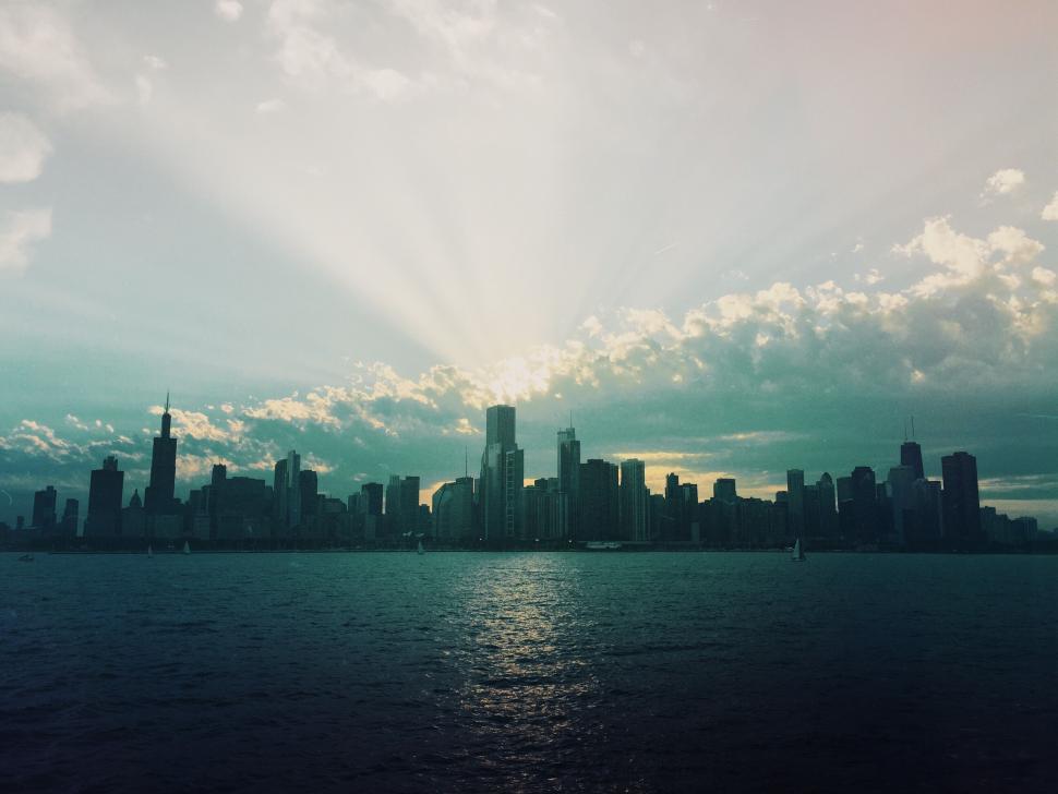 Free Image of Silhouette of a city skyline with a stunning sunset backdrop 