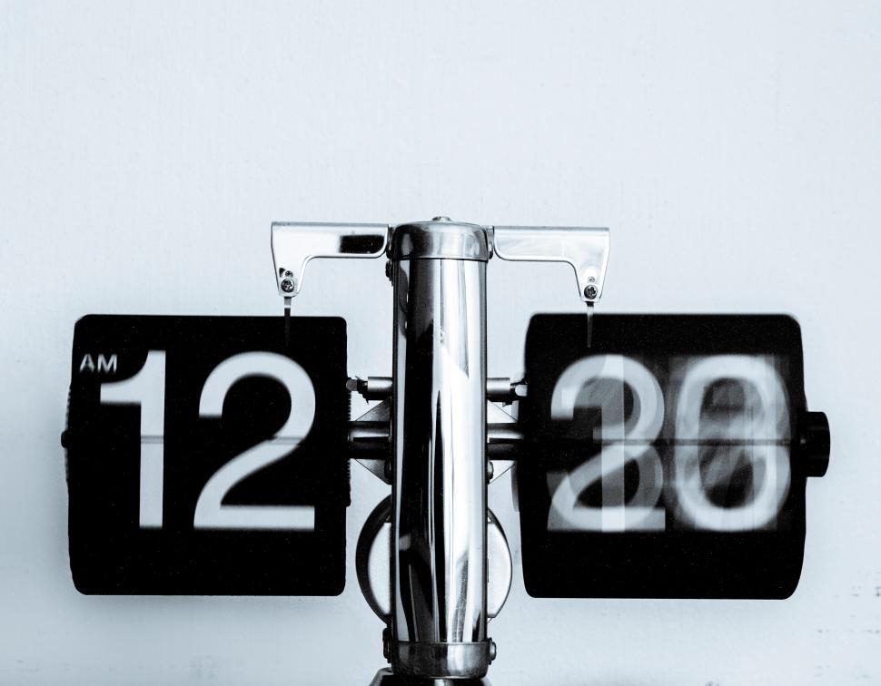 Free Image of Modern black and white flip clock showing time at 1220 AM 