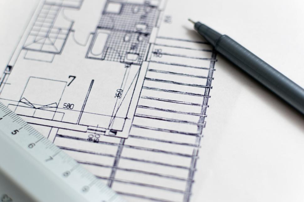 Free Image of Black pen and ruler on a detailed architectural blueprint draft. 