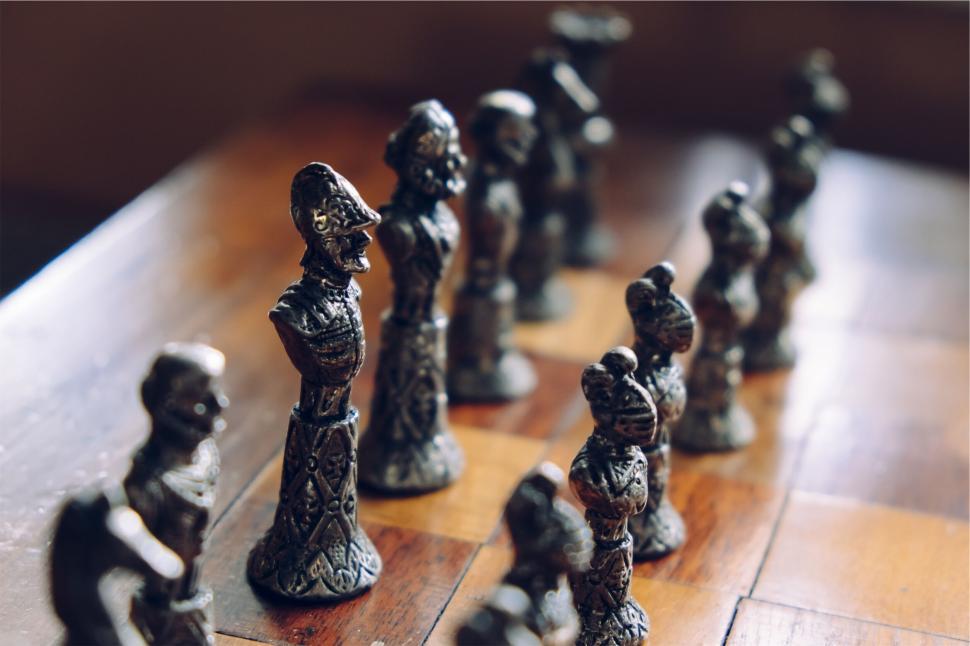 Free Image of Intricately Designed Metal Chess Set on a Wooden Board. 