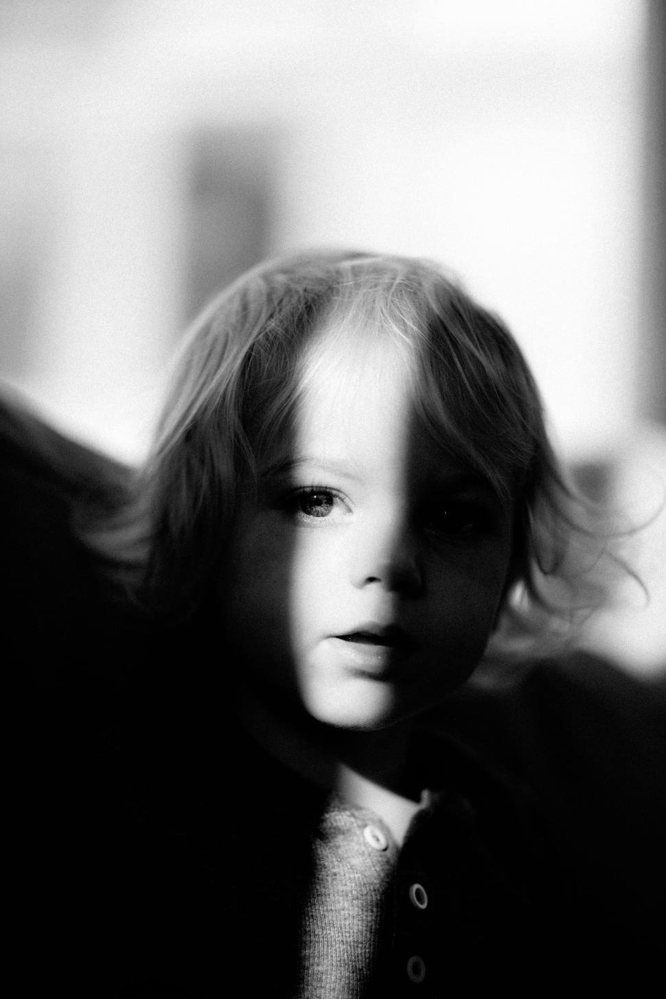 Free Image of Young Child in the Arms of an Adult in a Candid Moment. 