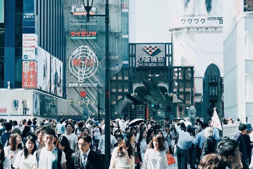Free Image of Crowded street in a busy city filled with people and advertisements 