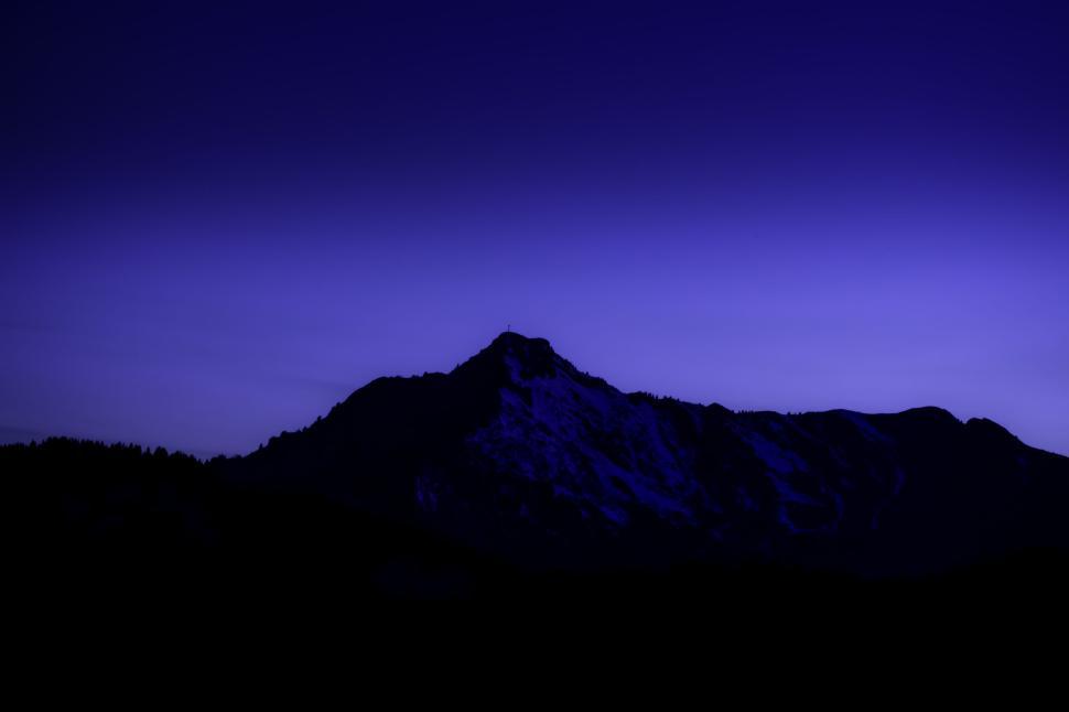 Free Image of Mountain silhouette under twilight sky creating serene ambiance. 