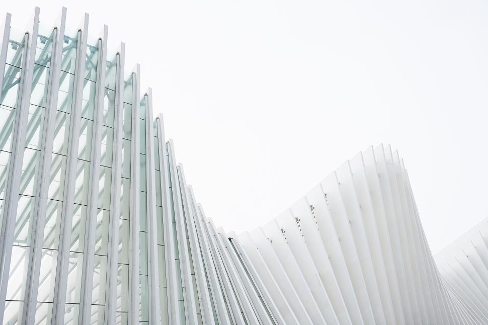 Free Image of Modern architectural design with white flowing structures forming curves 