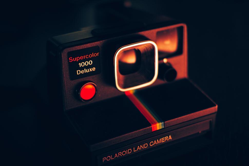Free Image of Vintage Polaroid camera with a rainbow stripe on the front shot. 
