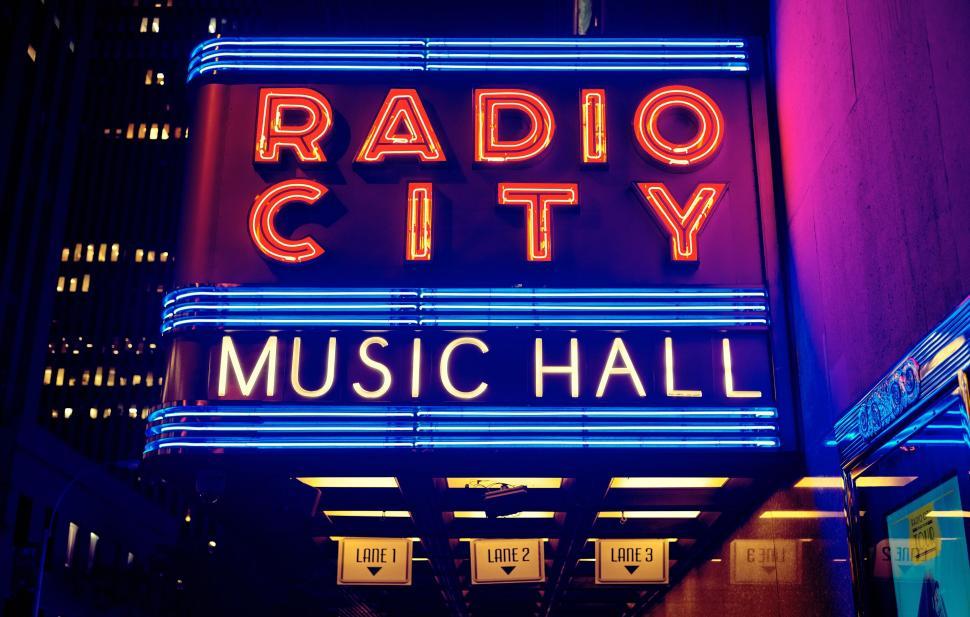 Free Image of Illuminated Radio City Music Hall sign glowing in vibrant night colors. 