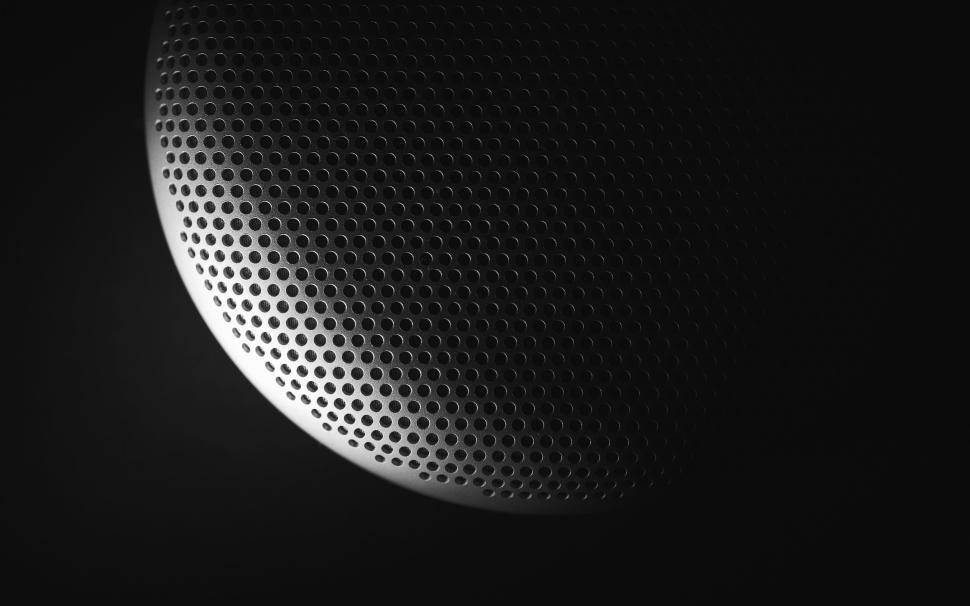 Free Image of Close-up of a modern black speaker grille in dramatic lighting. 